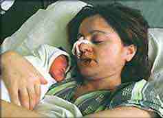A mother with a newborn baby in a Belgrade hospital, damaged by NATO during the Kosovo war