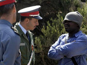 the man on the left is a Moroccan garda smart and true the man on the right is from sub sahara in his camp suit