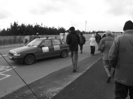 campaigners walk between the lorry and site entrance as it pulls up