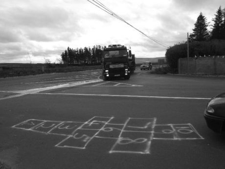 the lorry carrying a digger pulls up to the site entrance