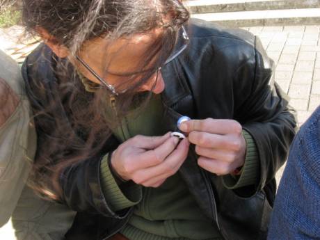 Markus affixes black shamrock beside German ploughshares badge