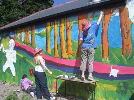 Ogra Corcaigh + Mayfield community arts centre paint a wall in the area