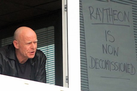 Veteran Civil Rights campaigner Eamon McCann addressin the protesters and media from the first floor window.