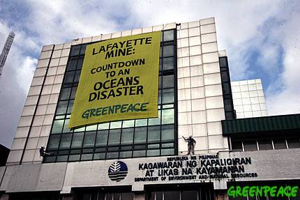 Click on image to see full-sized version Greenpeace activists unfurl a banner in protest over the conduct of the 30-day test run which the Department of Energy and Natural Resources granted to Australian mining Lafayette last month. © Greenpeace / Alex Baluyut