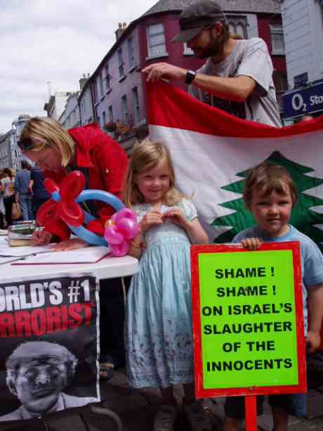 Eilis & Oisin over from London, their mum, Lois, signing our petition !.