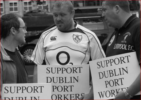 Joe Monney of the support group chatting with two of the strikers