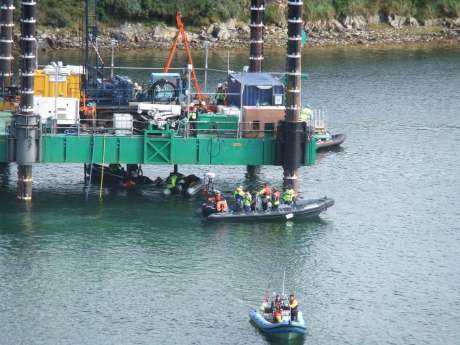 Garda picking up the swimmer under the platform from the clutches of the IRMS