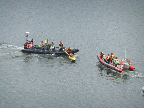 IRMS crew making a lunge for a kayaker