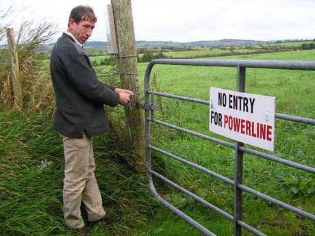 Micheal Roddy chaining the gate to a field in which the ESB plan to build a pylon