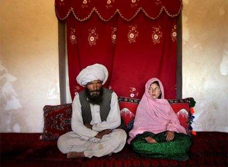 an arranged marriage in Afghanistan unites a 40 year old man & an 11 year old girl - their wedding photo gets UNICEF 1st prize 2007