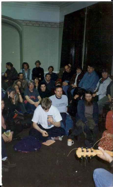 "Fossey" is pictured in the grey t-shirt to the righ of the white-t-shirted male in the foreground