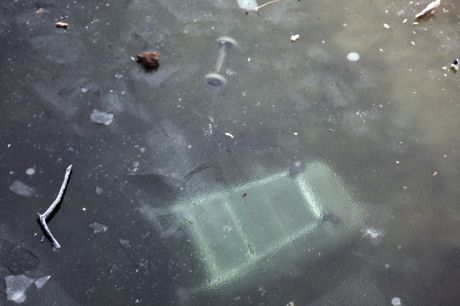 Shopping trolleys under the frozen canal