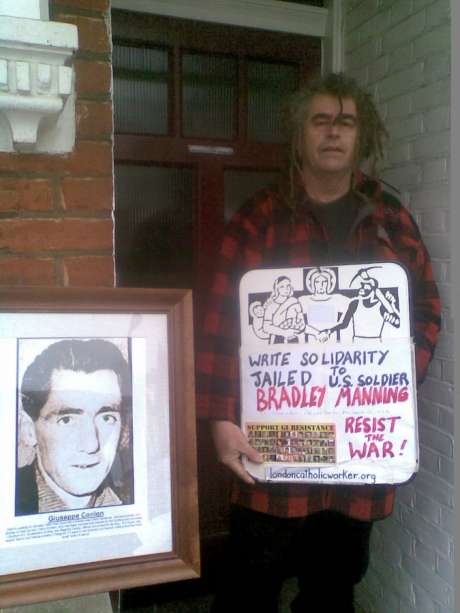 Ciaron O'Reilly with 'Write to Bradley Manning Placard' and Photo of Giuseppe Conlon