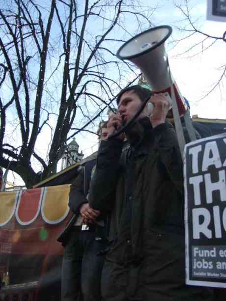 Gerry Carroll speaking to the crowd during Belfast'sstudent protest against university tuition fee increases and education cuts