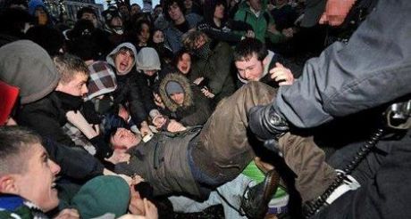 Gerry Carroll being dragged out of the crowd by officers