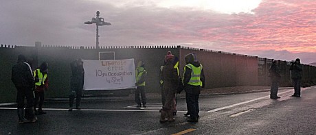 Unfurling the banner outside Aghoos compound