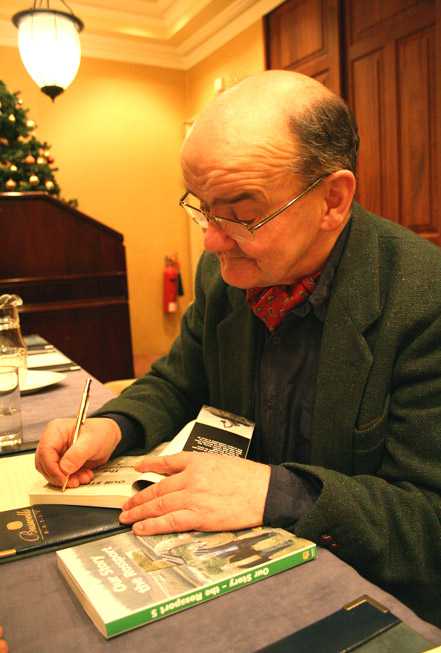 Michel  Seighin signs a copy of 'Our Story - the Rossport Five'
