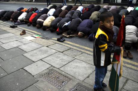 Praying for peace while young boy looks on