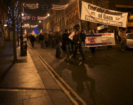 Anti-war protestors marching down  Derry's Shipquay Street calling for an end to the bombing of Gaza and for Derry City Council to tell Raytheon that they are no longer welcome in the city.