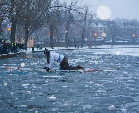 The first ice skater crosses over the ladder and unbelievably makes it across without falling into the water