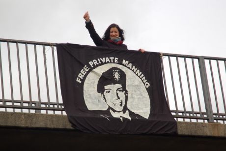 Sorcha Fox with the 'Free Private Manning' banner over the A40 in Pembrokeshire