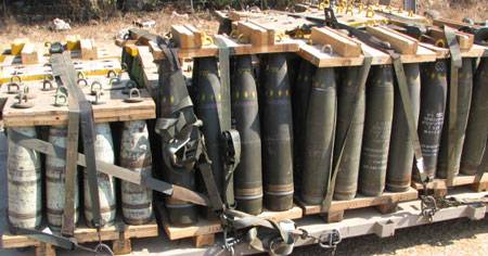 Pallets of 155mm artillery projectiles including DPICM cluster munitions (center and right with yellow diamonds) in the arsenal of an IDF artillery unit on July 23 in northern Israel. Each DPICM shell contains 88 sub-munitions, which have a dud rate of up