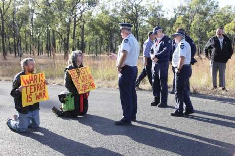 Click on image to see full-sized version Queensland Police prepare to arrest peace activists Jim Dowling & Ciaron O’ Reilly for blocking military vehicles access to the Talisman Sabre military training facility.