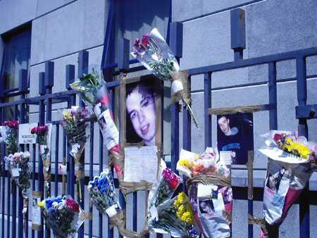 Floral tributes on the fence of Store St Garda Station