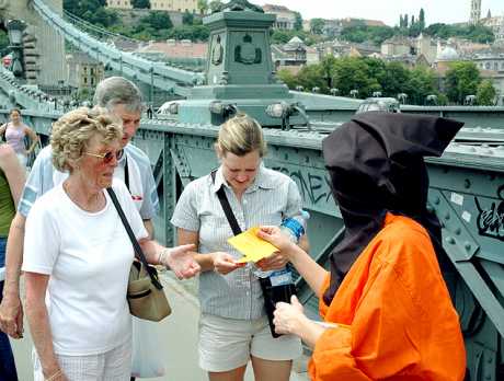 confused tourists reading flyers from GITMO POW
