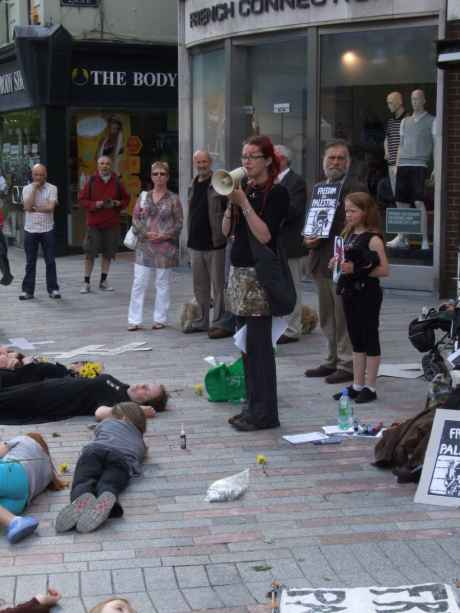 Click on image to see full-sized version Caroline speaking to vigil observers and passers-by