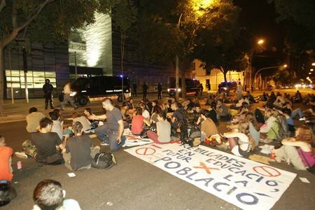 Indignants sit in at the Copshop holding centre awaiting the release of detainees after assuring the world "it wasn't us".