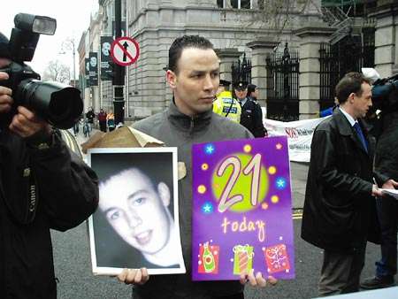 Robert Wheelock with a picture of Terence and a 21st birthday card for him.