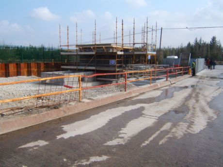 View of reception building mid construction just inside gate one. 