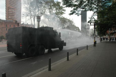 riot squad uses water cannon in central Bogota
