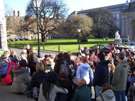 Carol talking to the first tour at Trinity College. In the background is the statue of Provost Salmon, who famously said that women would be admitted to Trinity College over his dead body. 