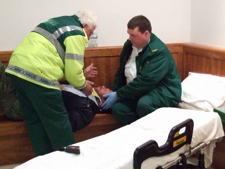 Paramedics deal with Niall in the foyer of the court