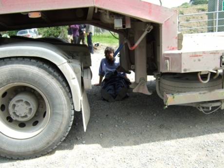 Protester under the lorry