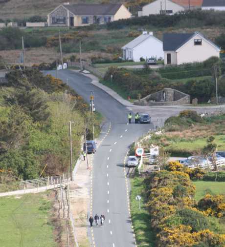 One of the Garda roadblocks set up on both sides of Glengad.  Notice the campaign supporters in the foreground walking the rest of the way to the action location. Only locals were allowed drive through, other vehicles had to be left at roadblock.