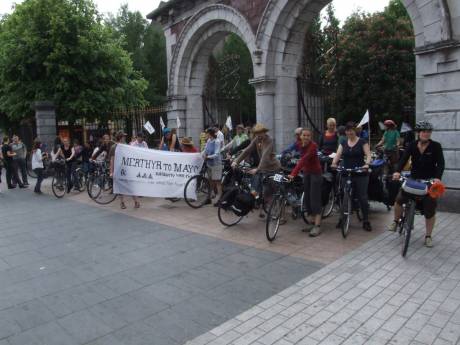 Cyclists assemble at the park gates