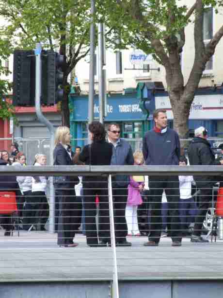 Hard-working plainclothes 'welcomers' having a conflab.  Spot the Yardie?