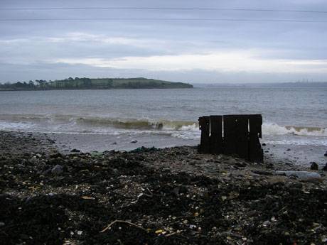The sea shore beside the site; the site has been subject to flooding