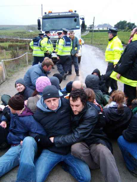 Campaigners block the exit of Lennon's quarry with a sit down.
