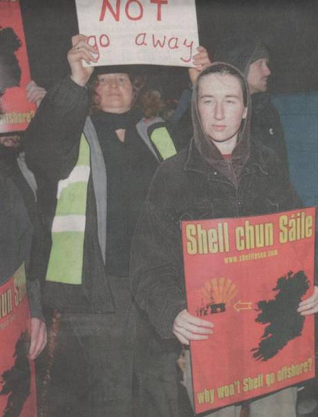 A mean-looking subversive wields a dangerous poster in an obviously threatening manner