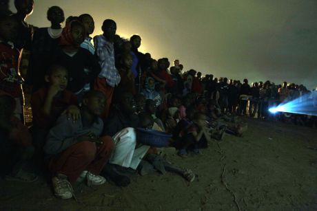 Crowds gather to watch what Slum-TV has been filming