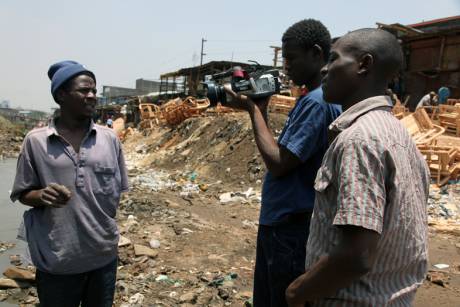 Victor and Collins interview a local worker for the newsreel to be broadcast the following week