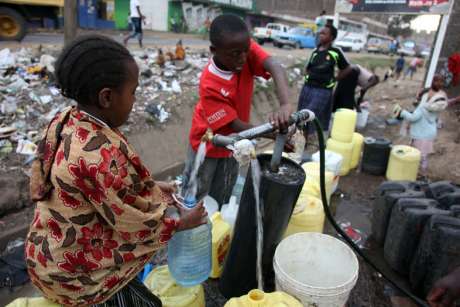Children collecting water after the supply was re-instated.