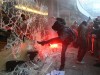 UK: A demonstrator kicks in a window at Millbank Tower, Tory HQ