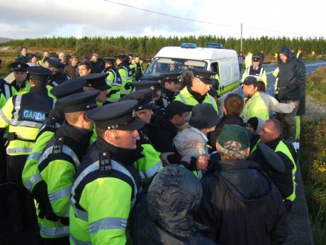 A Garda minibus is forced through the crowd of protesters.