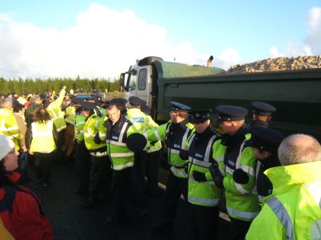 Police allow trucks through the blockade.
