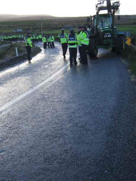 Police march back up the "Shell highway"